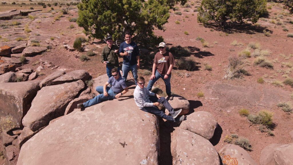 Group of young men on rocky hill in Arizona during Navajo mission trip